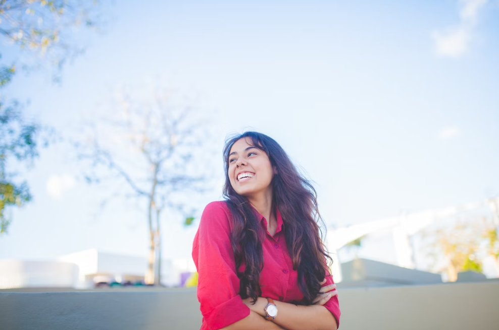 Smiling teenage girl standing outdoors. 