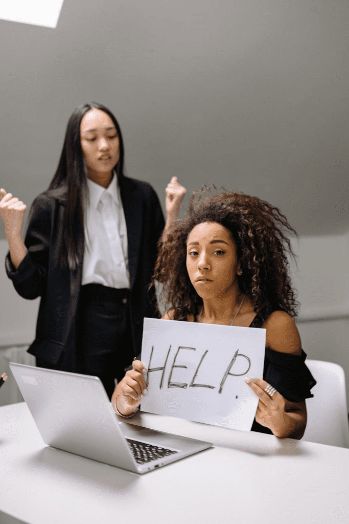 A person holds up a sign asking for help.